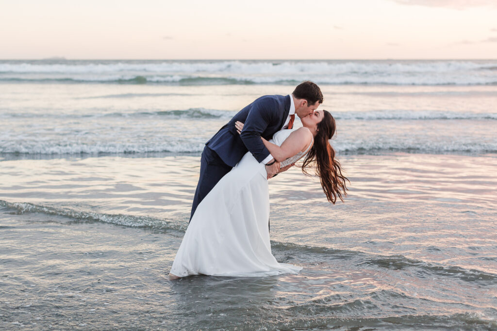 a bride and groom in the ocean. It's important to look at what setting to get married at when answering the question is a destination wedding right for you?