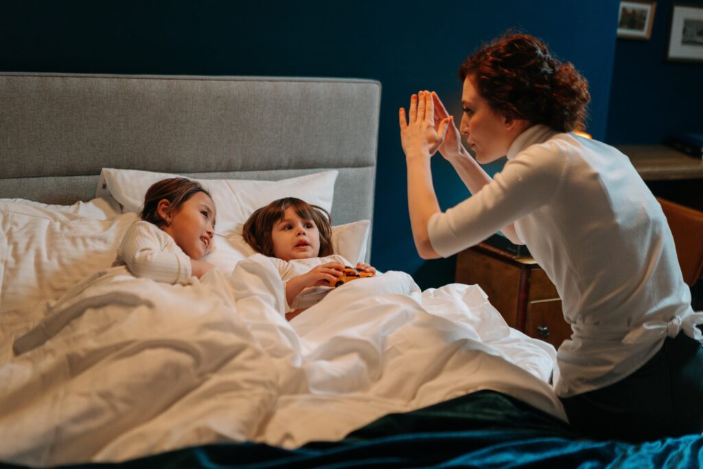 Nanny putting kids to bed at a kid-friendly destination wedding resort.